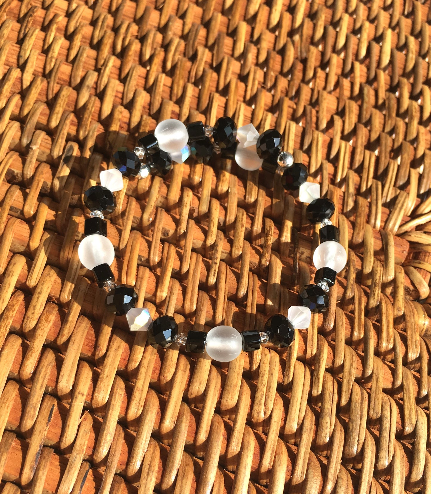 Black faceted and cube beads and white faceted beads memory wire bracelet