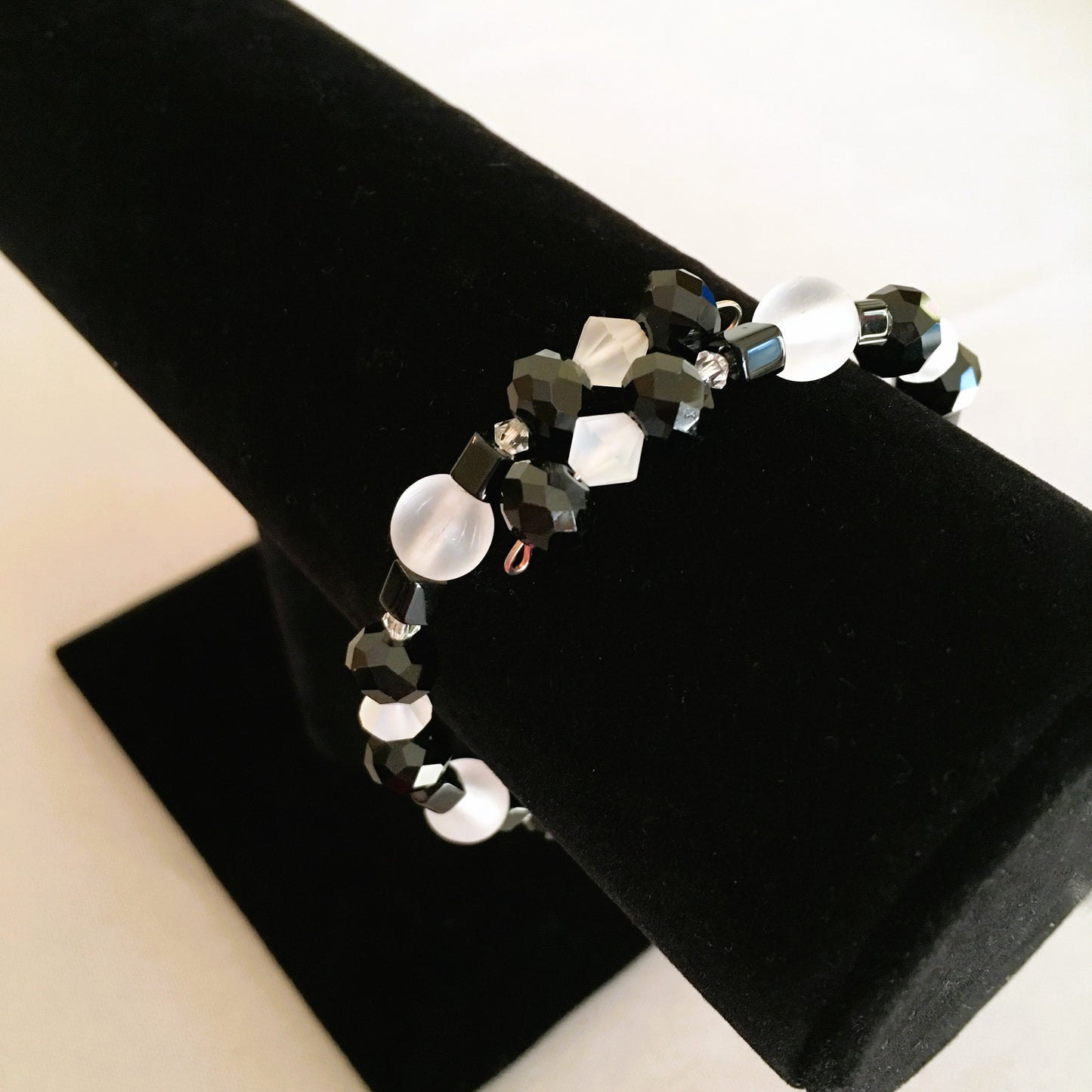 Black faceted and cube beads and white faceted beads memory wire bracelet
