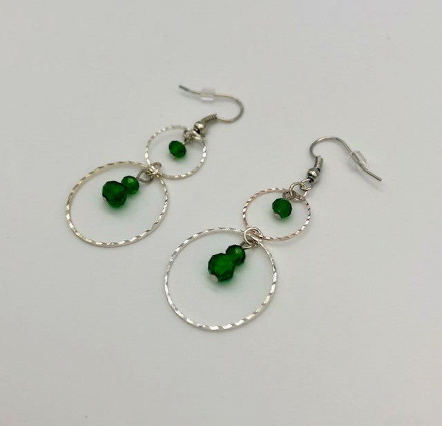 Emerald green glass beads in circle cutout earrings