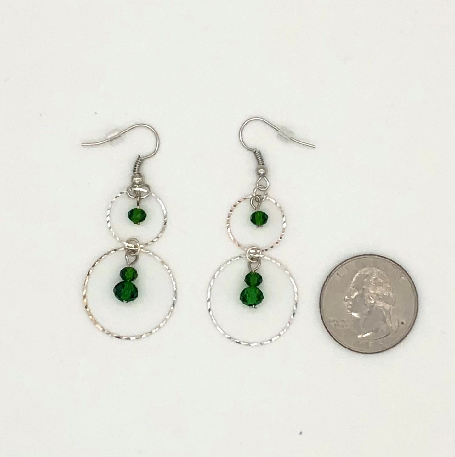 Emerald green glass beads in circle cutout earrings