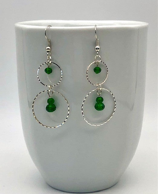 Emerald green glass beads in circle cutout earrings