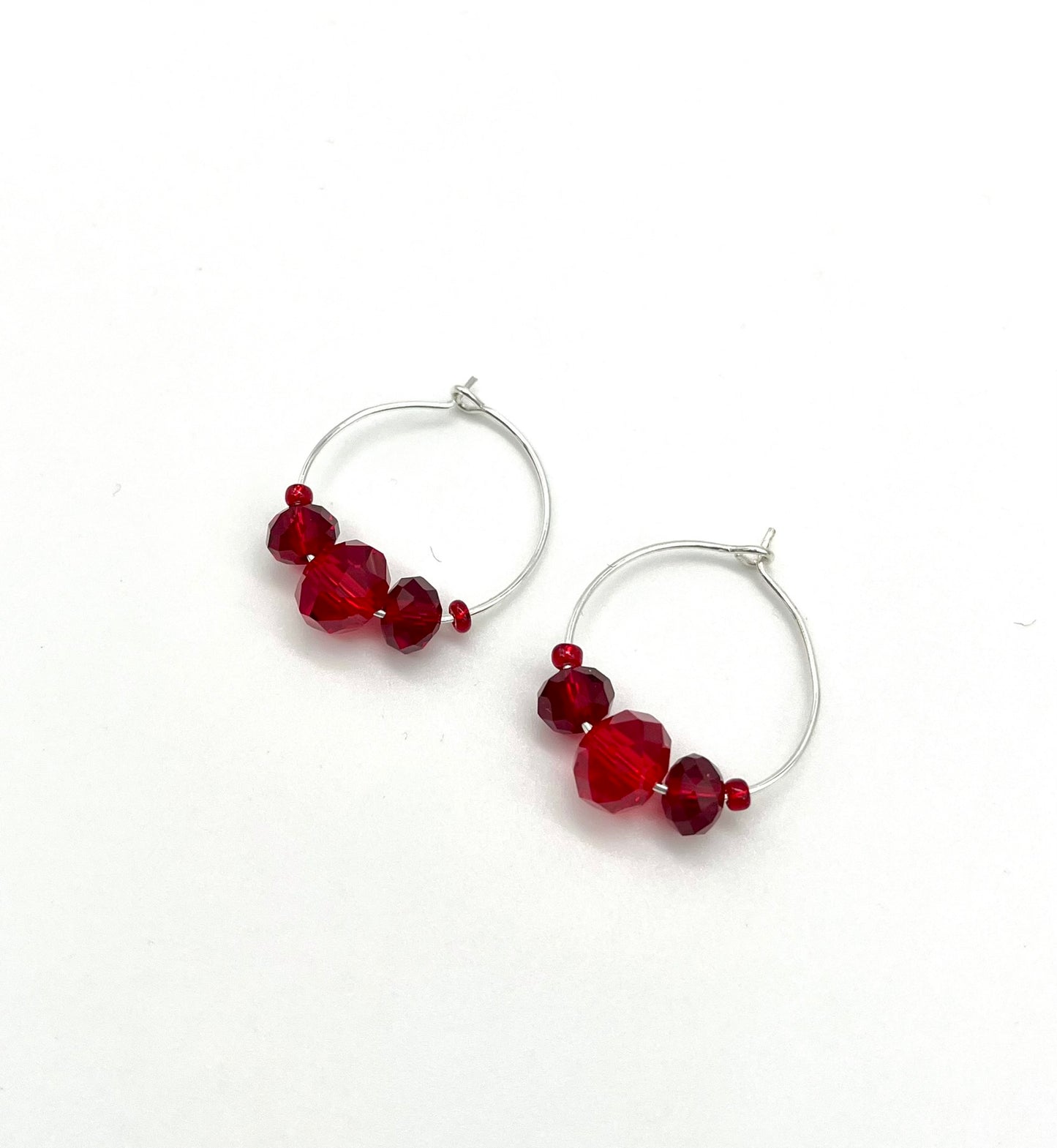 Silver hoop earrings with glass bead detail