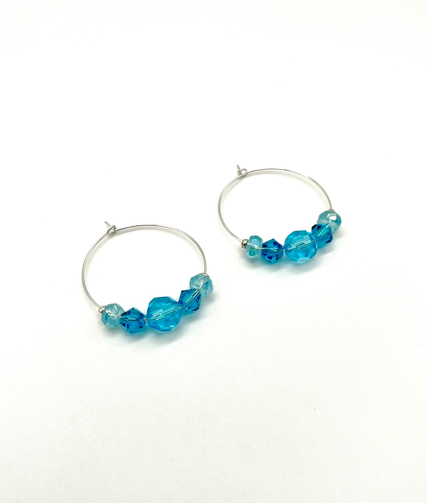 Silver hoop earrings with glass bead detail
