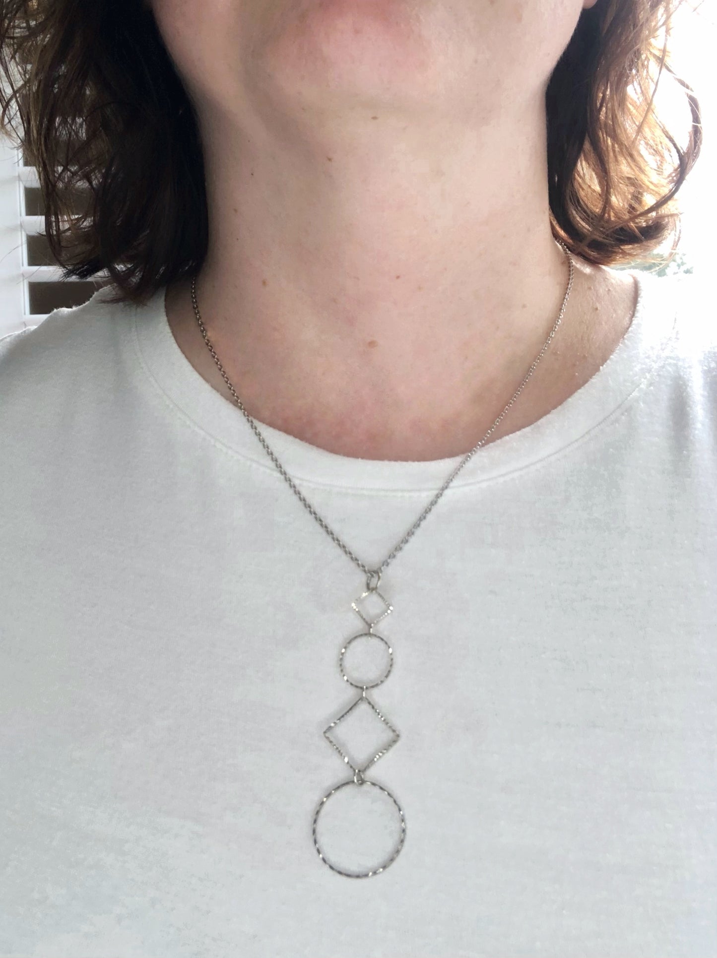 Silver-plated laser cut circle and diamond shape pendant on chain necklace