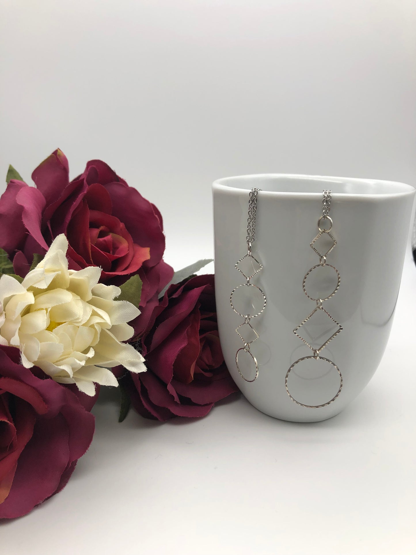Silver-plated laser cut circle and diamond shape pendant on chain necklace