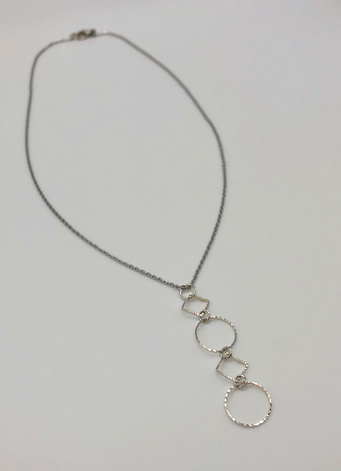Silver-plated laser cut circle and diamond shape pendant on chain necklace