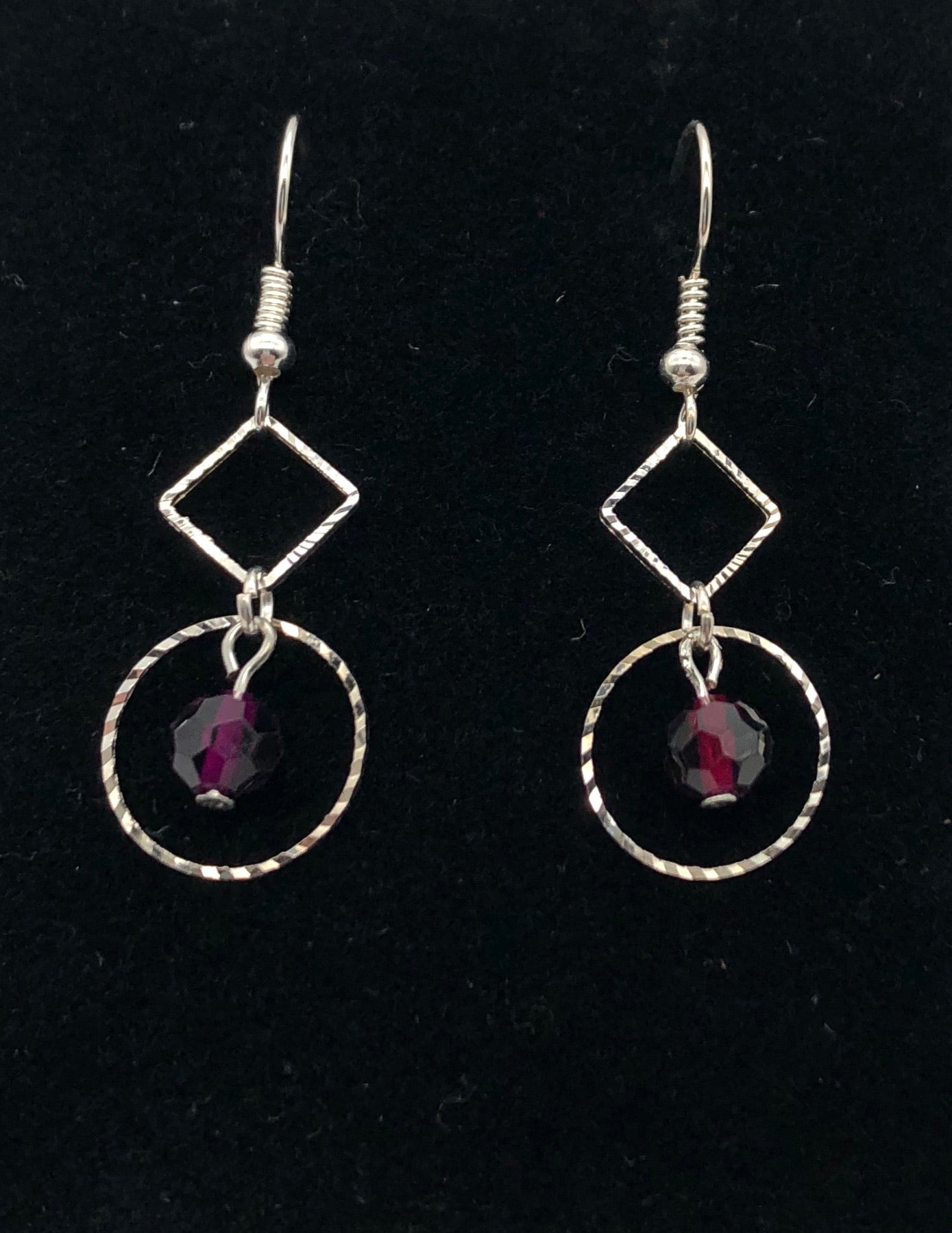 Purple faceted bead with diamond and circle shaped cutout dangly earrings