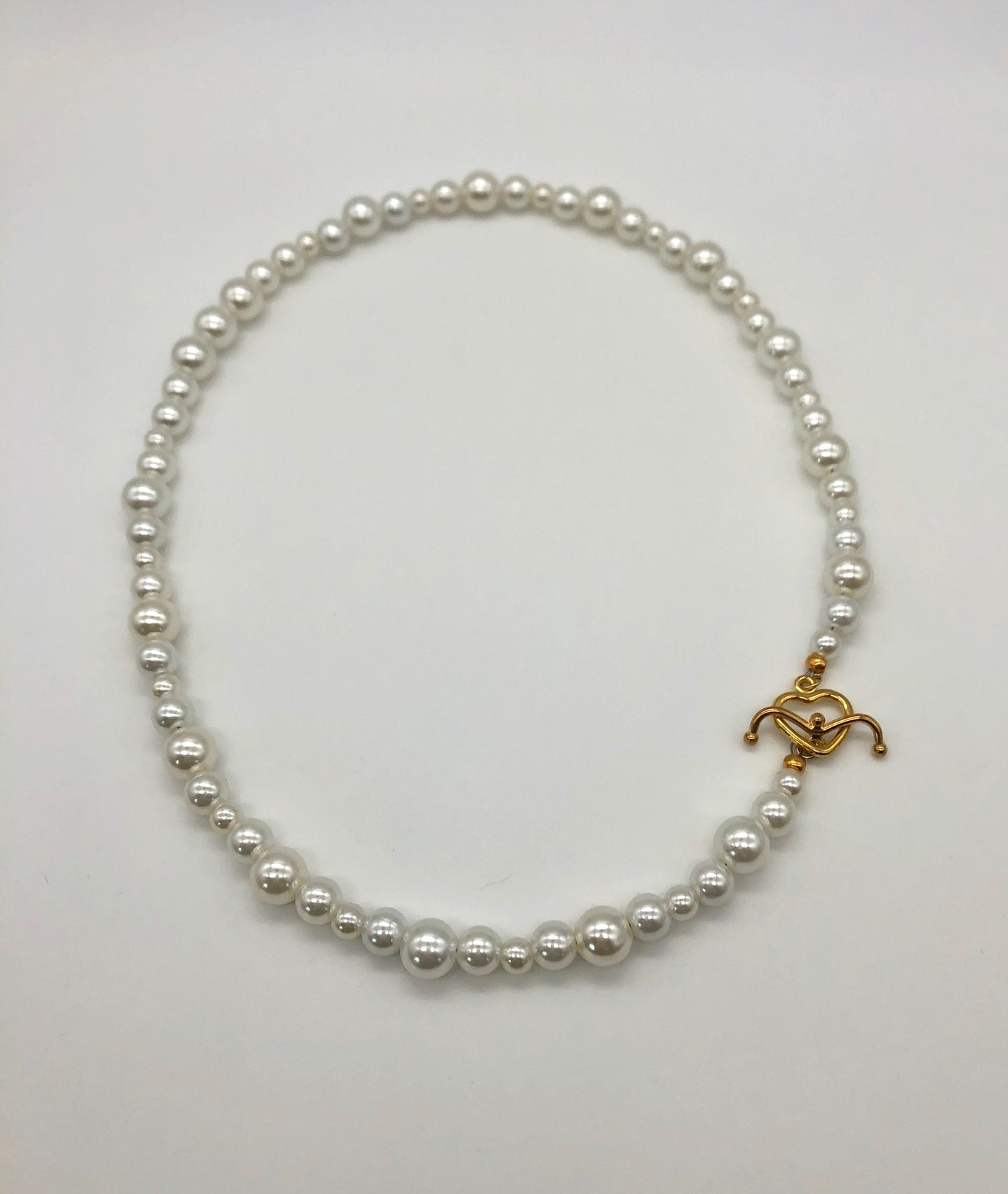 Faux pearl bead necklace with gold plated heart toggle clasp
