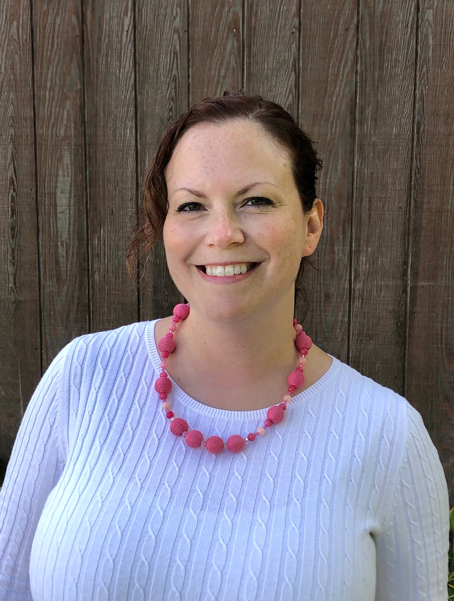 Pink rhodonite, crystal, and cotton beaded necklace