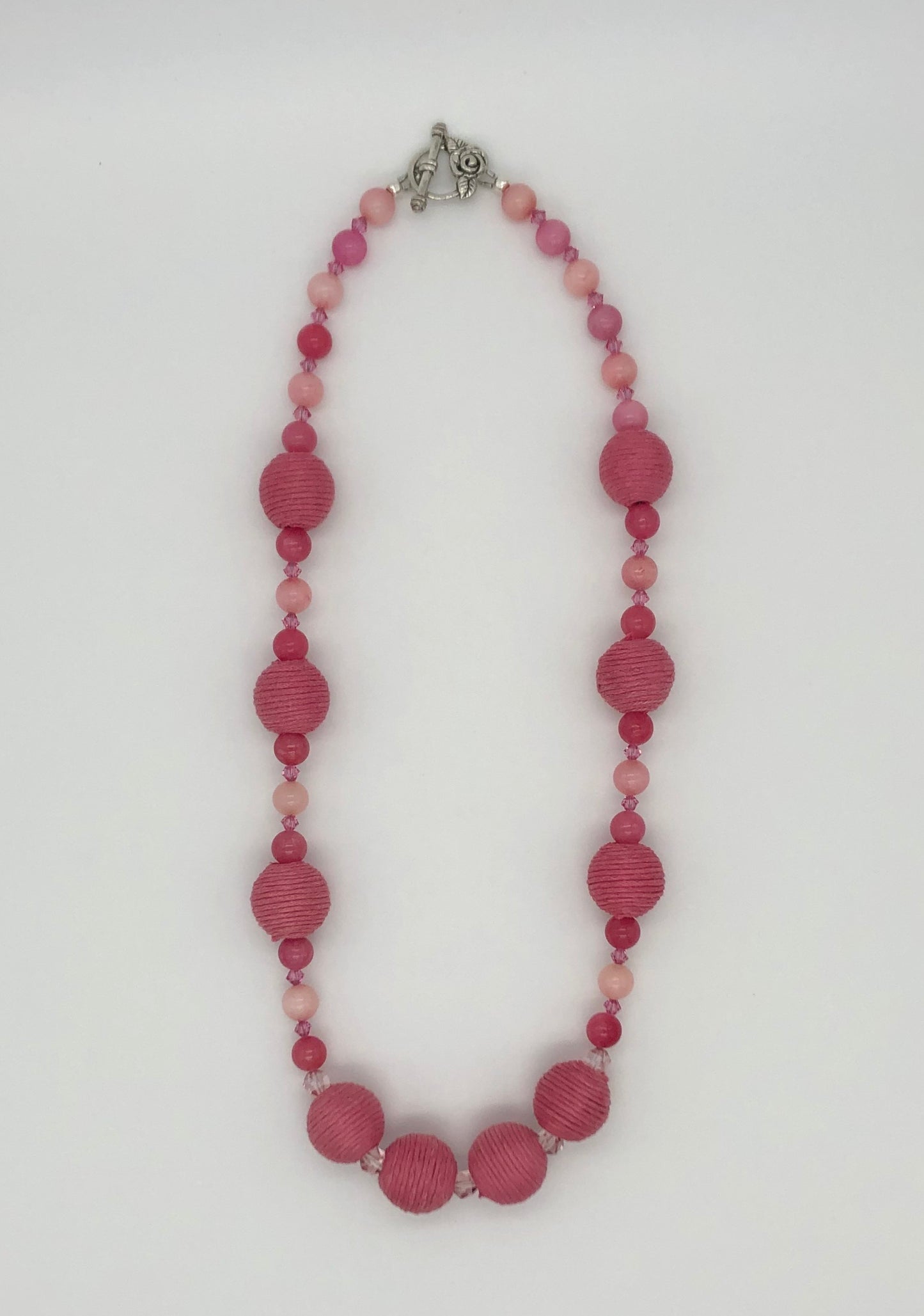 Pink rhodonite, crystal, and cotton beaded necklace