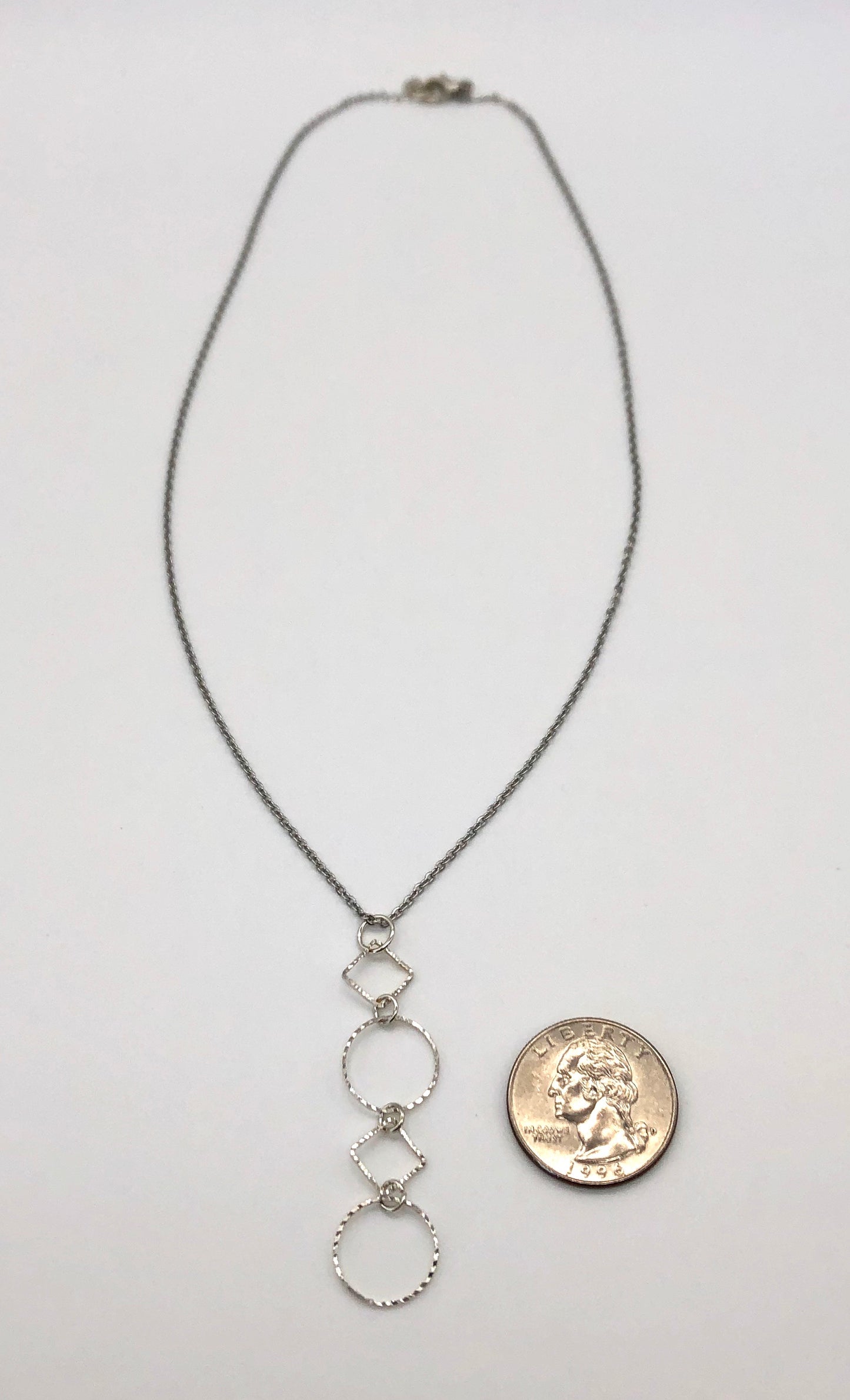 Silver-plated laser cut circle and diamond shape pendant on chain necklace