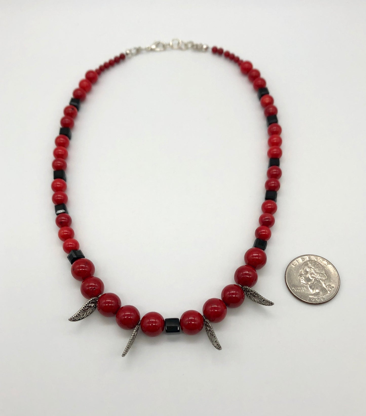 Red round stone and black faceted bead with leaf detail necklace