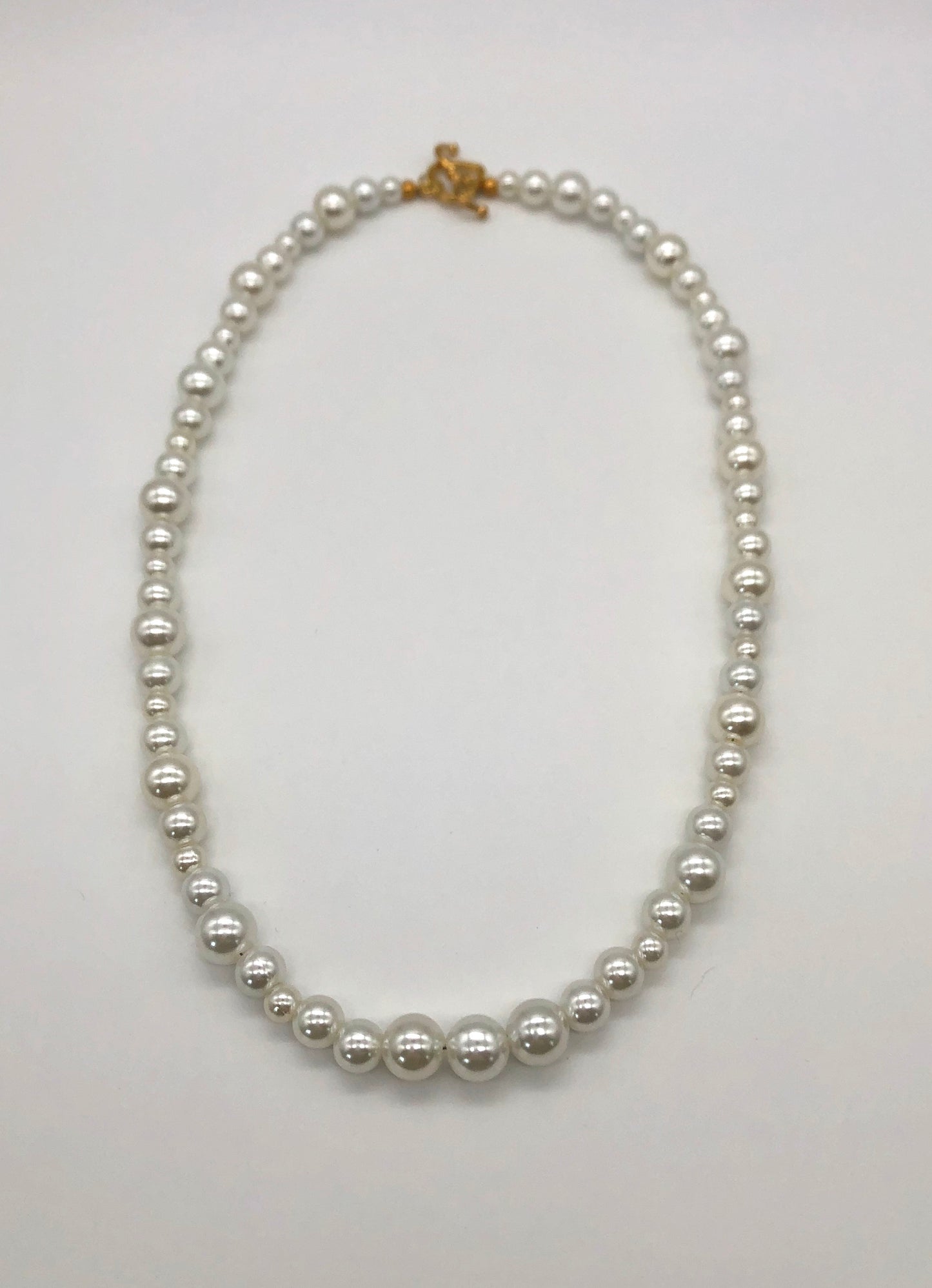 Faux pearl bead necklace with gold plated heart toggle clasp