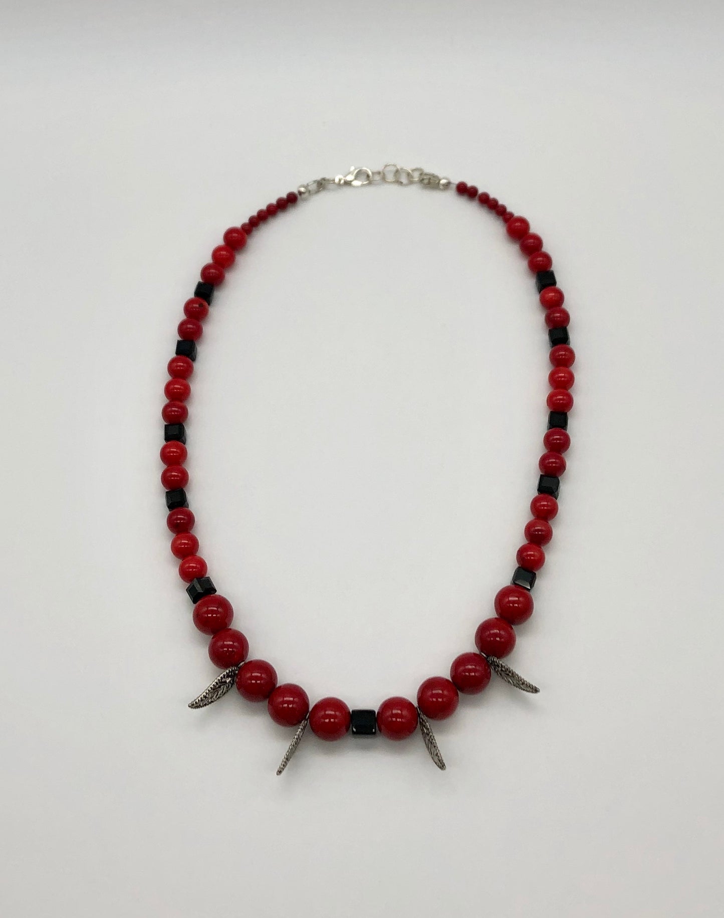 Red round stone and black faceted bead with leaf detail necklace