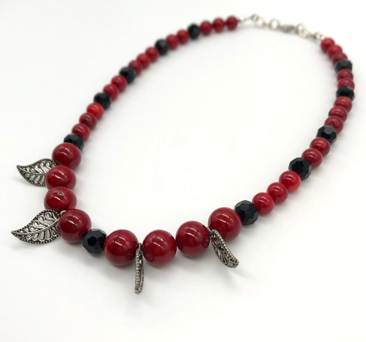 Red round stone and black faceted bead with leaf detail necklace