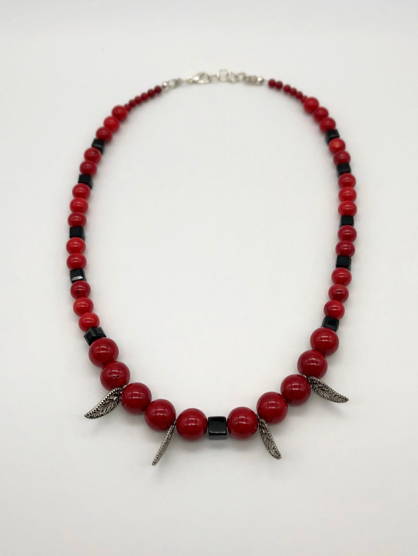 Red round stone and black faceted bead with leaf detail necklace