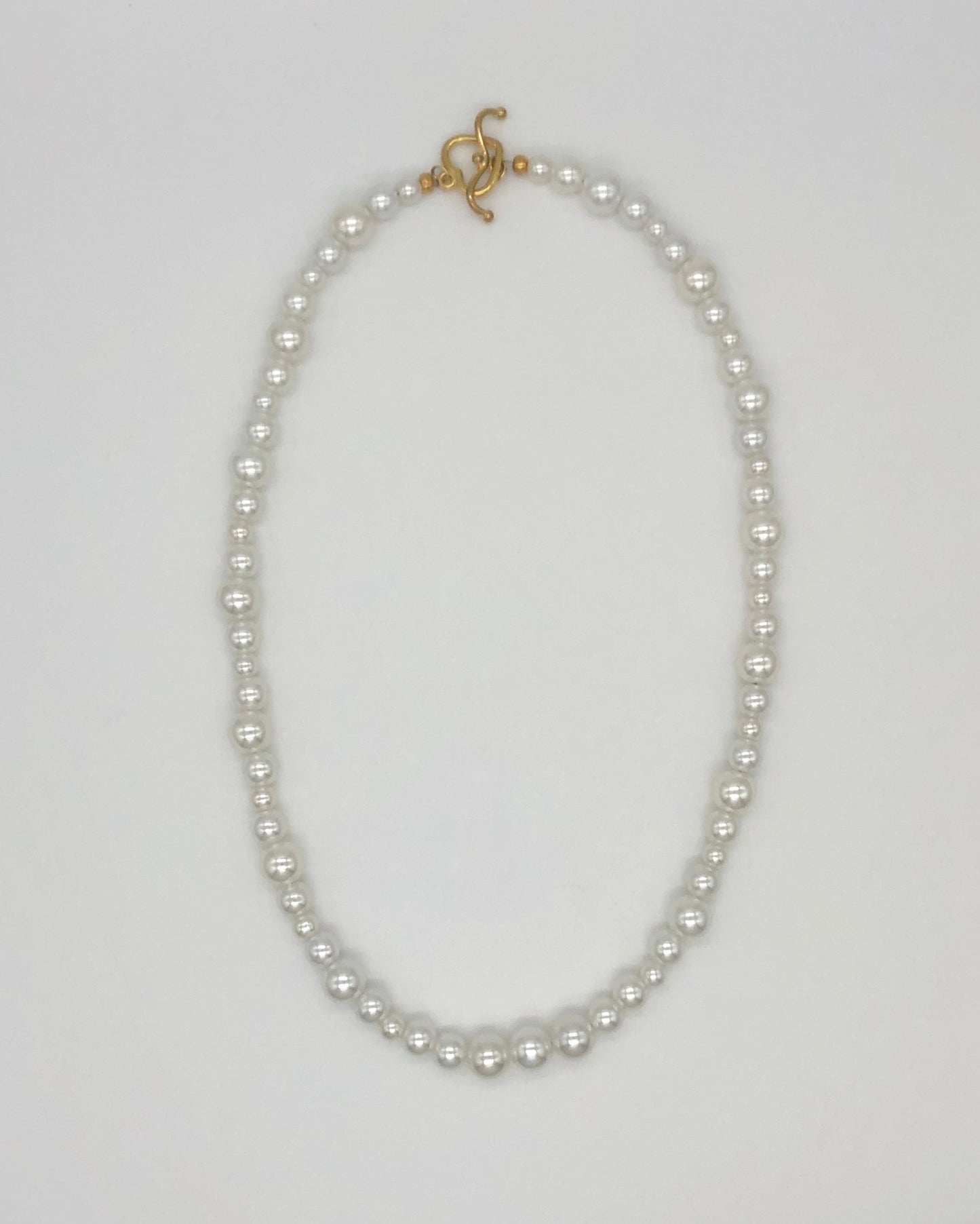 Faux pearl bead necklace with gold plated heart toggle clasp