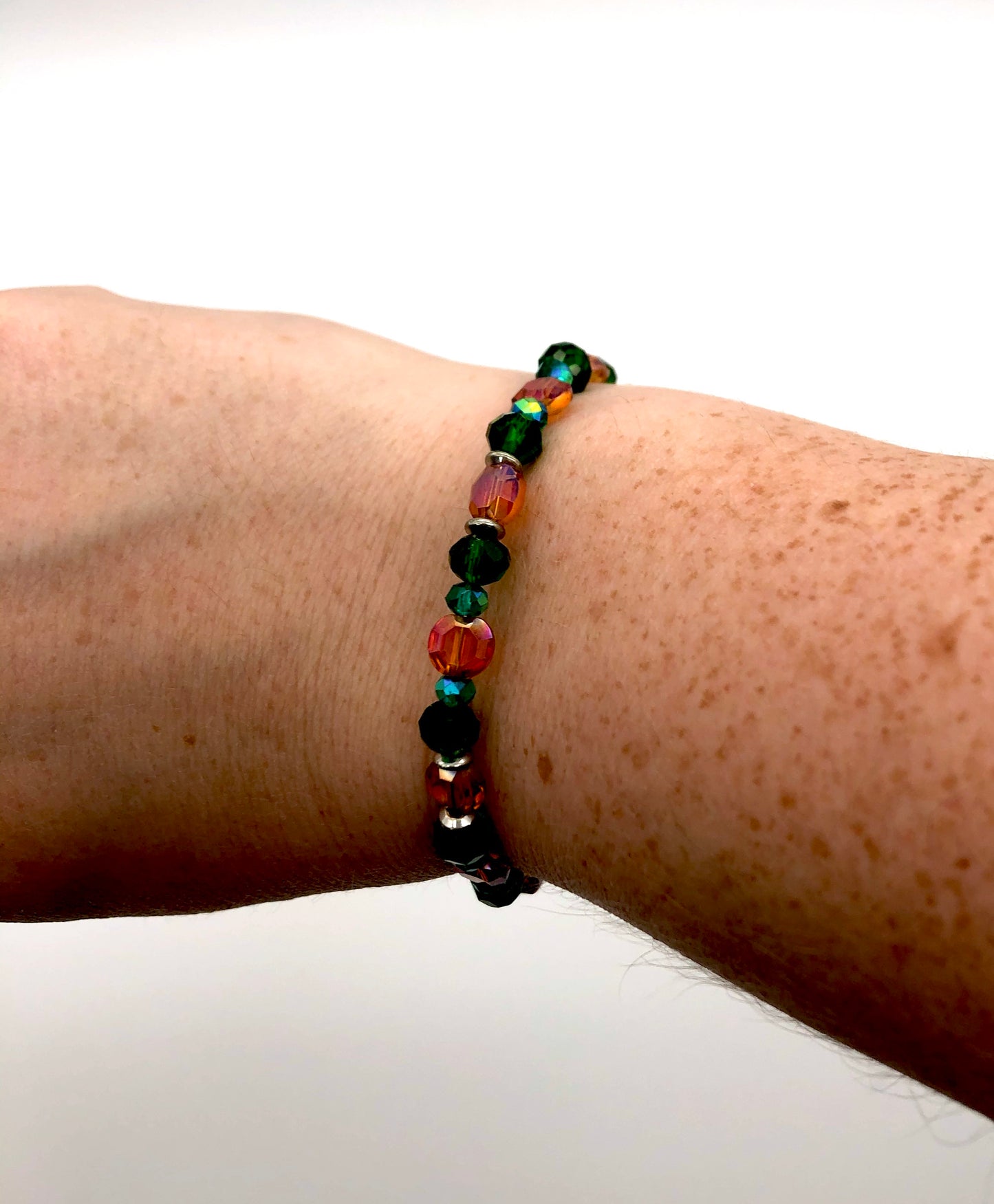 Orange lentil and green faceted beaded memory wire bracelet