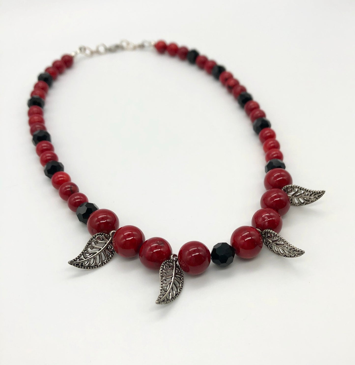 Red round stone and black faceted bead with leaf detail necklace