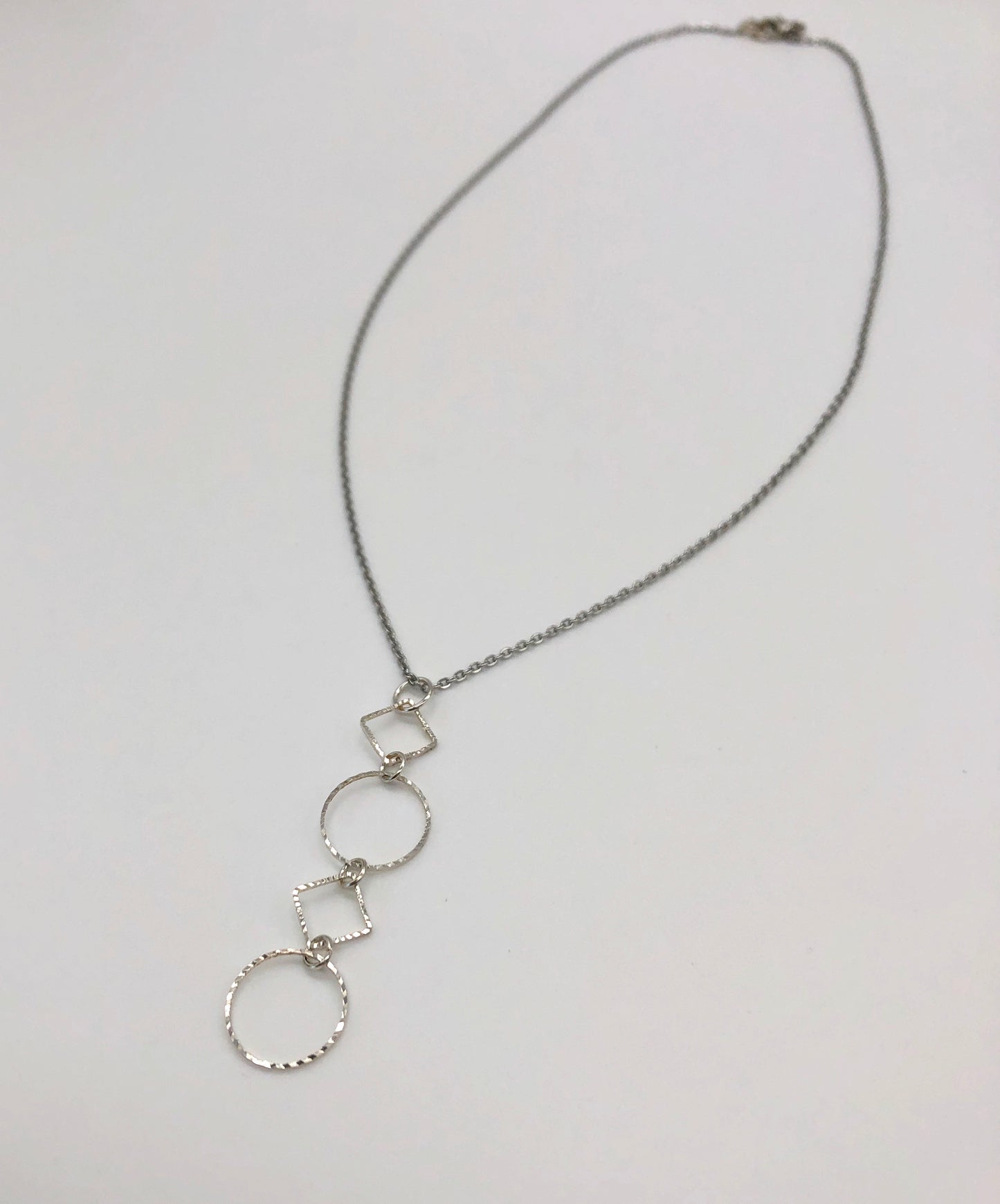 Silver-plated laser cut circle and diamond shape pendant on chain necklace