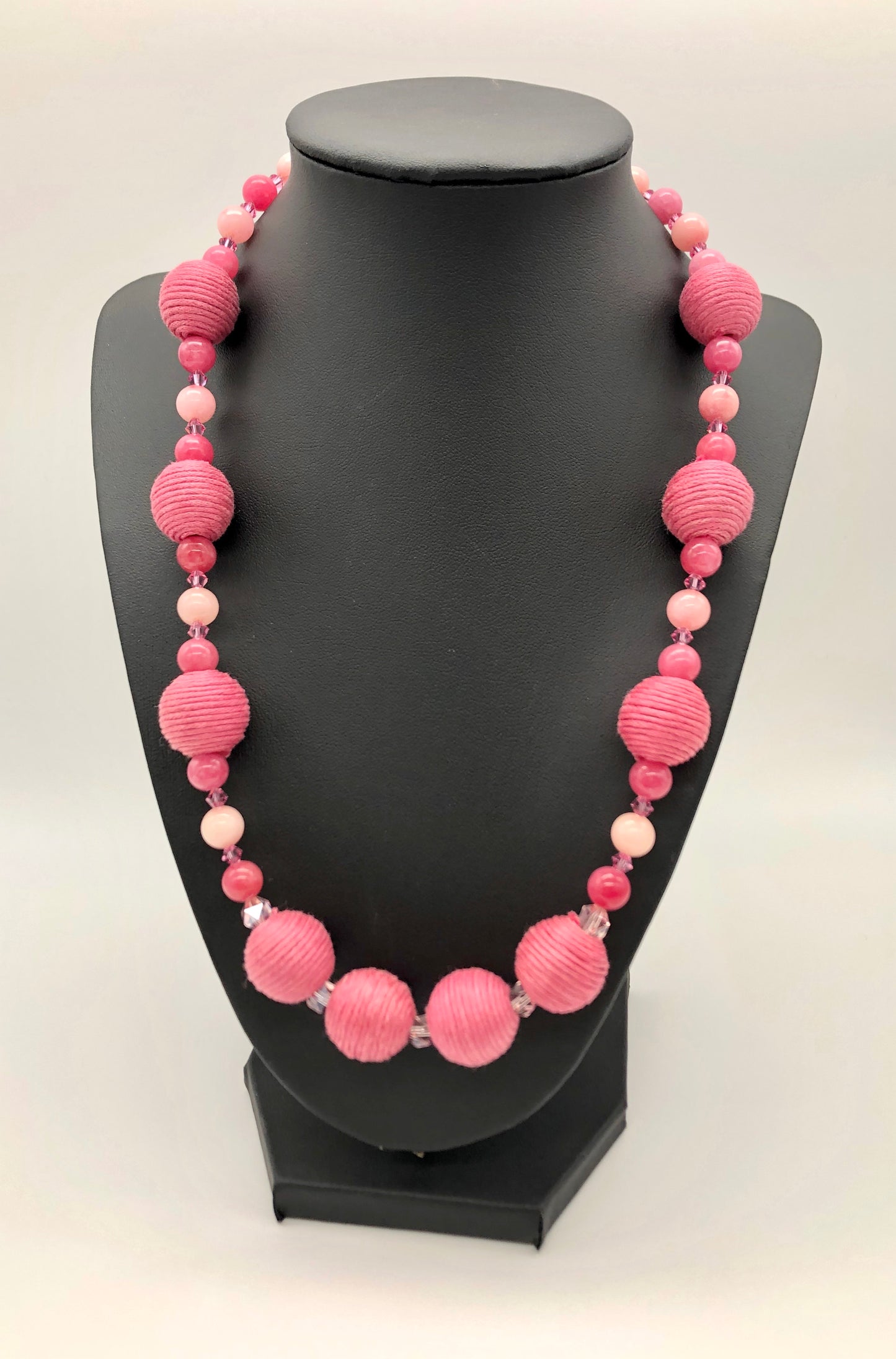 Pink rhodonite, crystal, and cotton beaded necklace