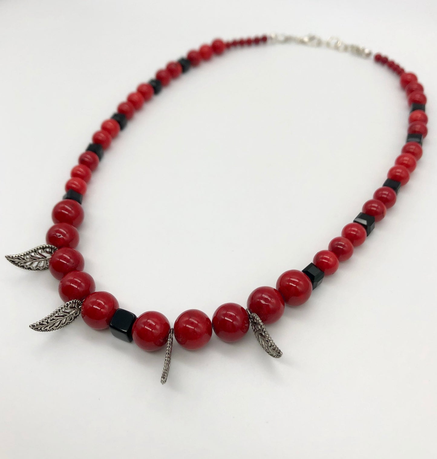 Red round stone and black faceted bead with leaf detail necklace