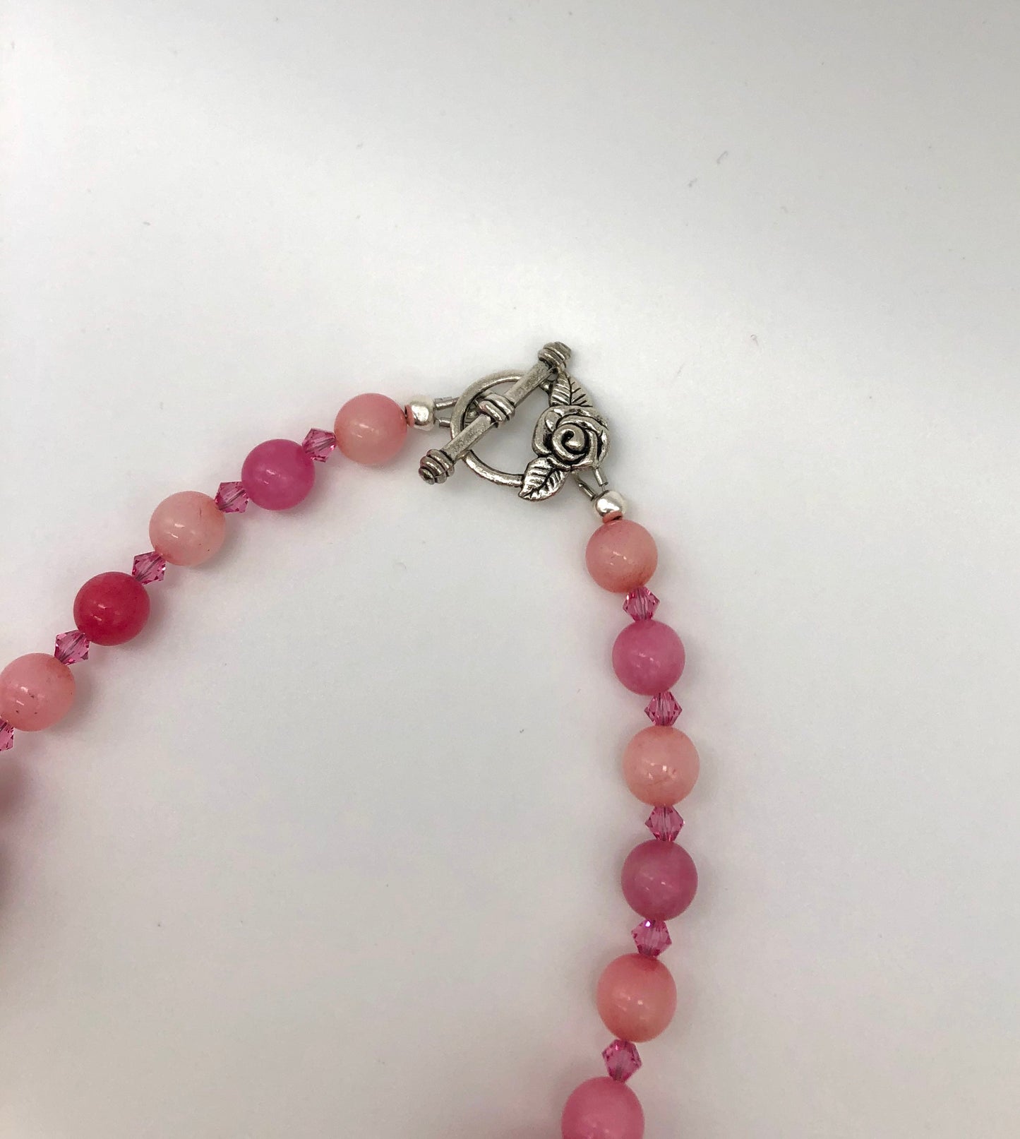 Pink rhodonite, crystal, and cotton beaded necklace