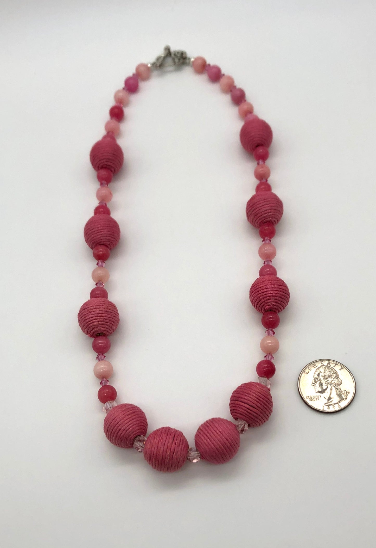Pink rhodonite, crystal, and cotton beaded necklace